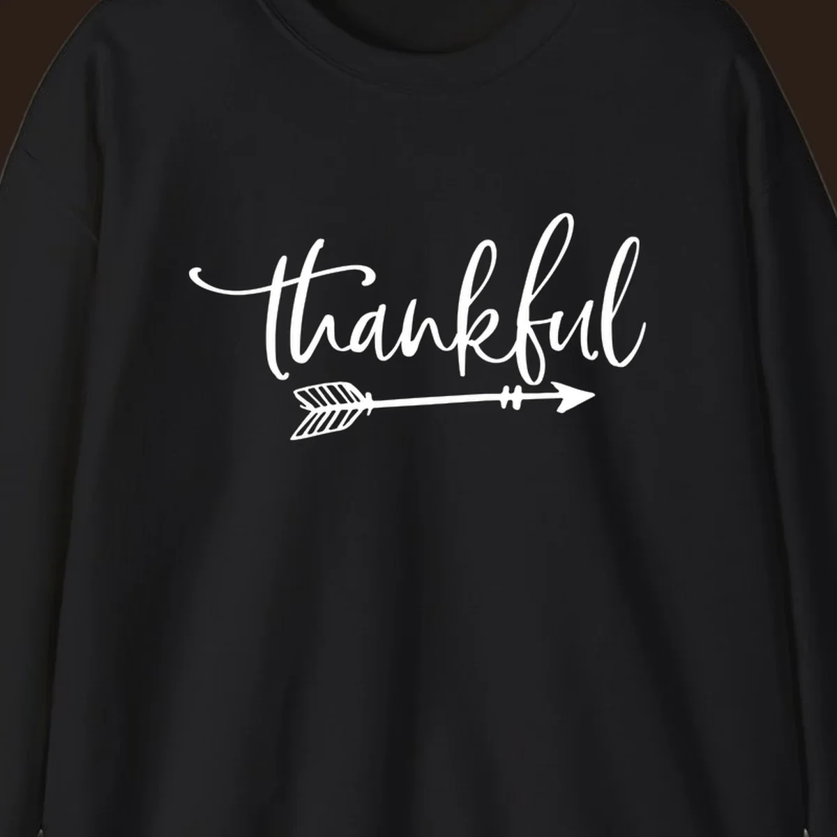 Thankful text with an arrow graphic, Thanksgiving theme.