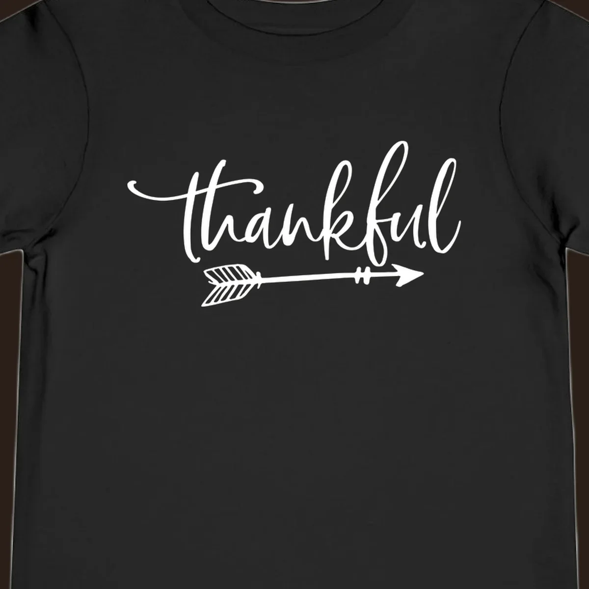 Thankful text with an arrow graphic, Thanksgiving theme.