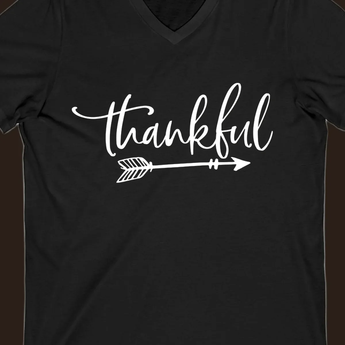 Thankful text with an arrow graphic, Thanksgiving theme.