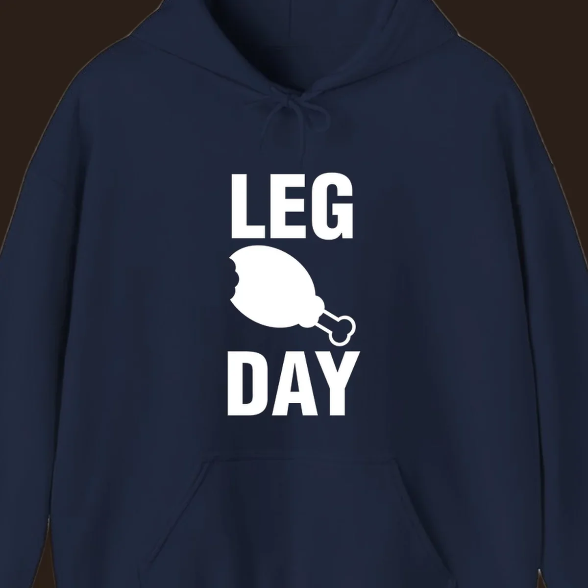 Leg Day text with a bitten chicken leg graphic. Humor fitness design.