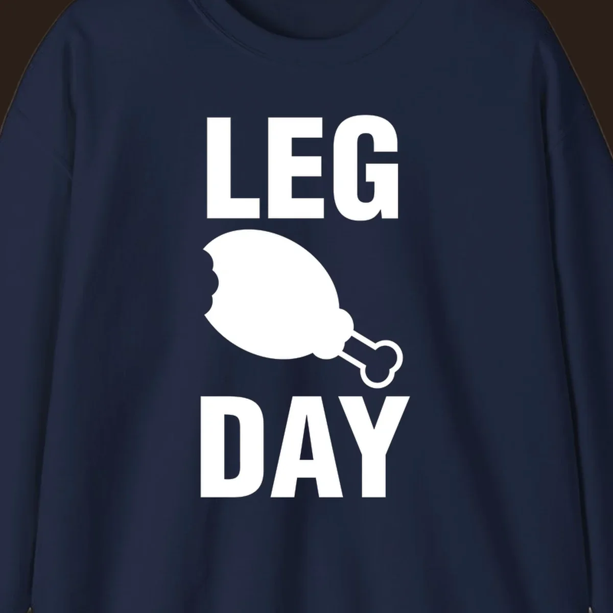 Leg Day text with a bitten chicken leg graphic. Humor fitness design.