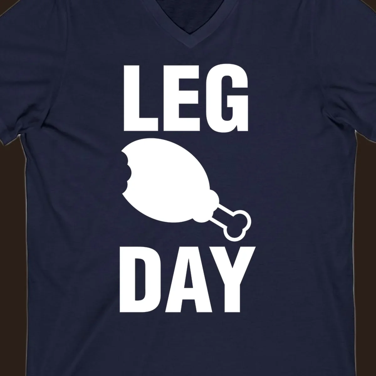Leg Day text with a bitten chicken leg graphic. Humor fitness design.