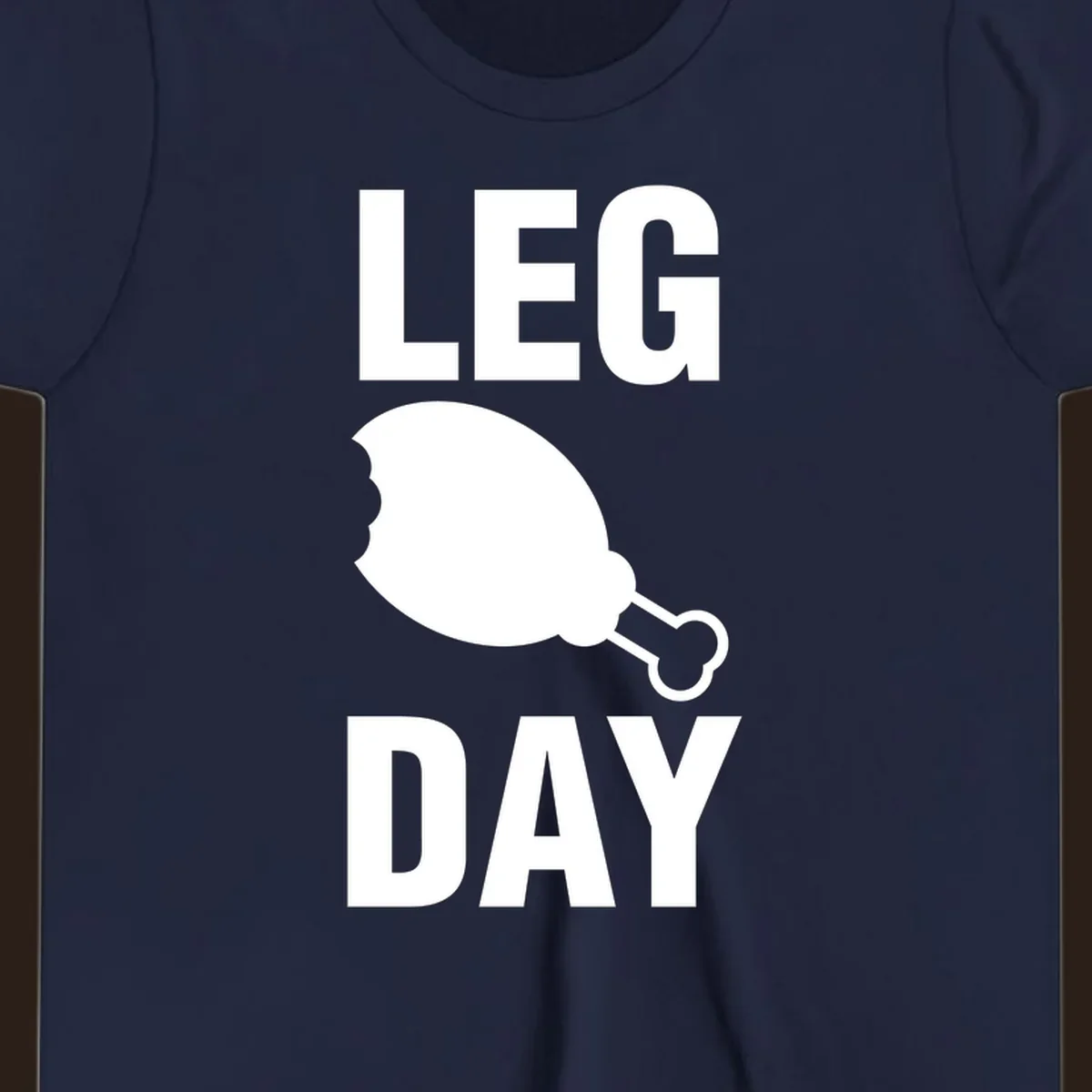 Leg Day text with a bitten chicken leg graphic. Humor fitness design.