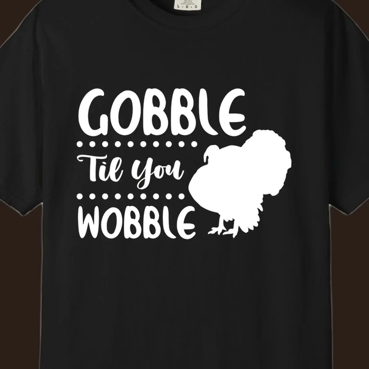 Gobble til you wobble turkey design with text and a turkey silhouette.