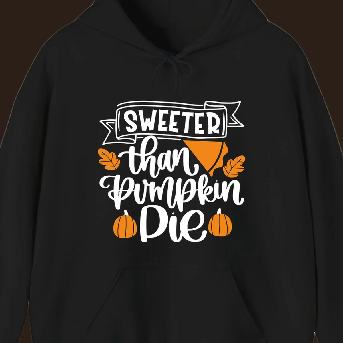 Sweeter than pumpkin pie thanksgiving design with text, pie slice, leaves, and pumpkins.