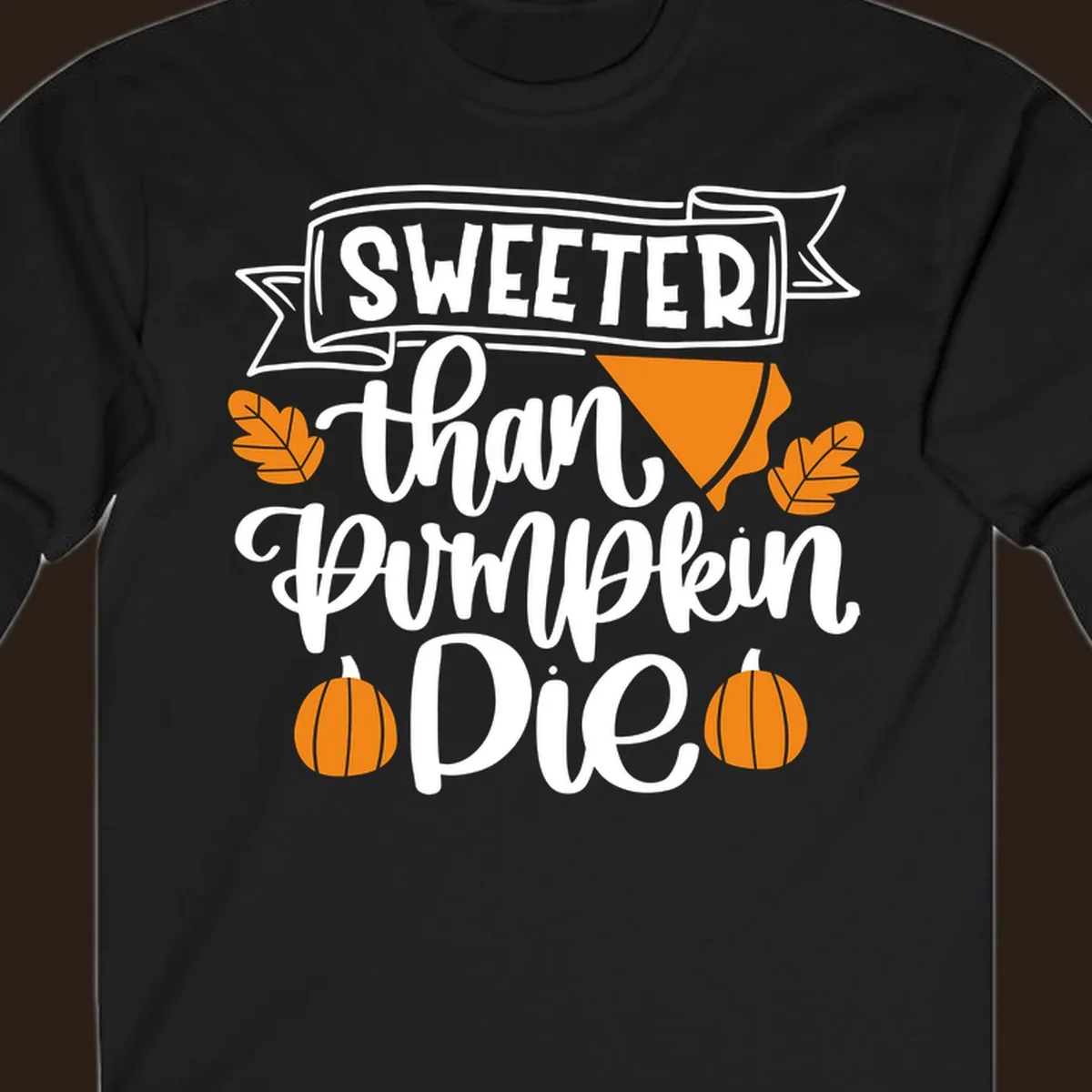 Sweeter than pumpkin pie thanksgiving design with text, pie slice, leaves, and pumpkins.