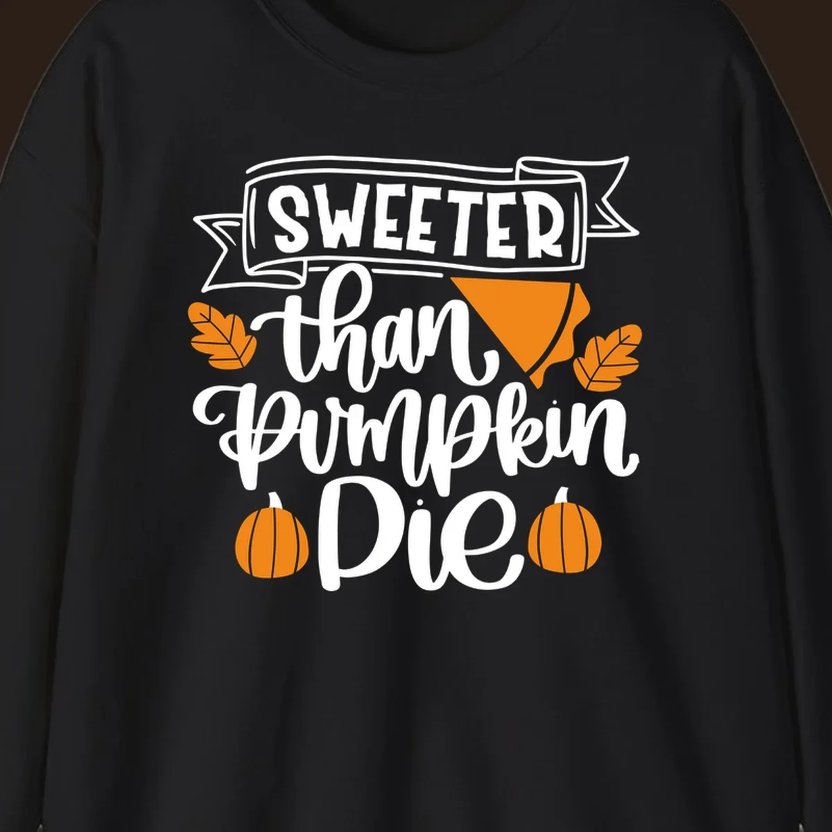 Sweeter than pumpkin pie thanksgiving design with text, pie slice, leaves, and pumpkins.