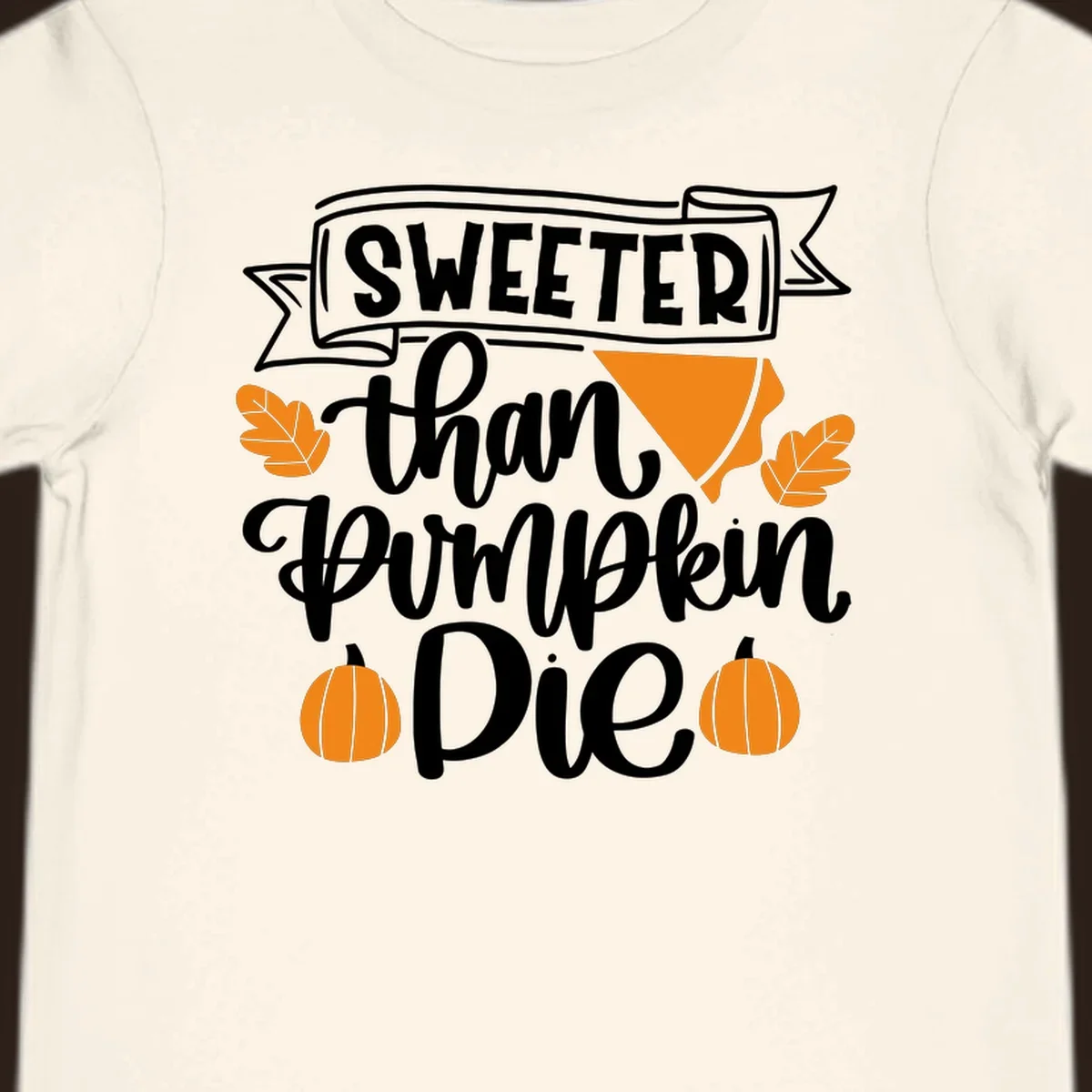 Sweeter than pumpkin pie thanksgiving design with text, pie slice, leaves, and pumpkins.