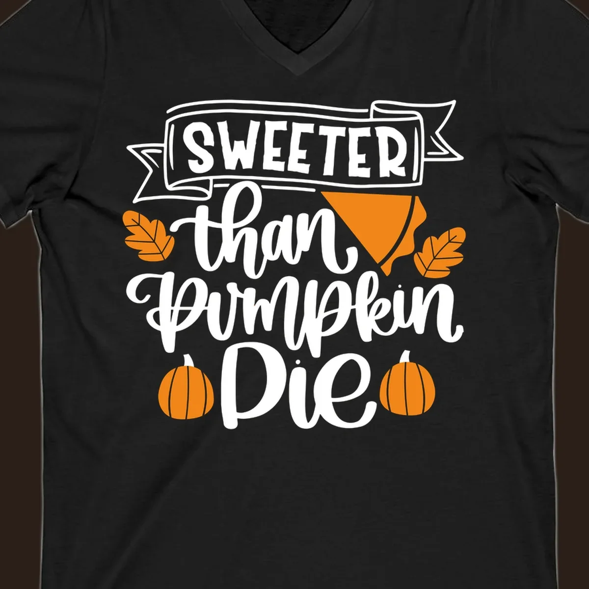 Sweeter than pumpkin pie thanksgiving design with text, pie slice, leaves, and pumpkins.
