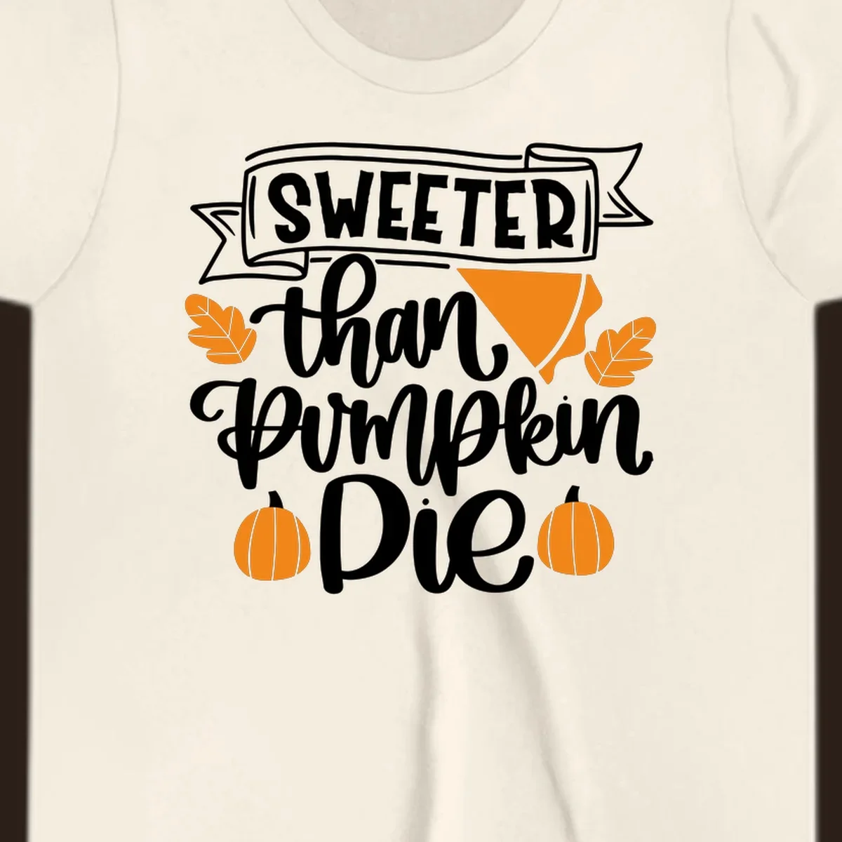 Sweeter than pumpkin pie thanksgiving design with text, pie slice, leaves, and pumpkins.