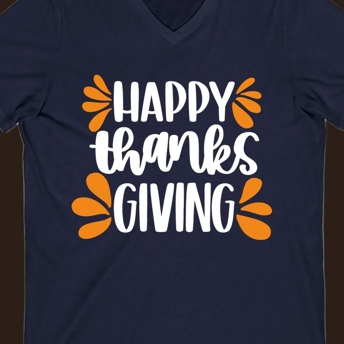 Happy Thanksgiving text with orange leaf accents, typography design.