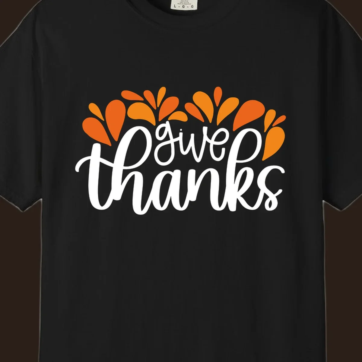 give thanks leaves design with white script text and orange leaf shapes