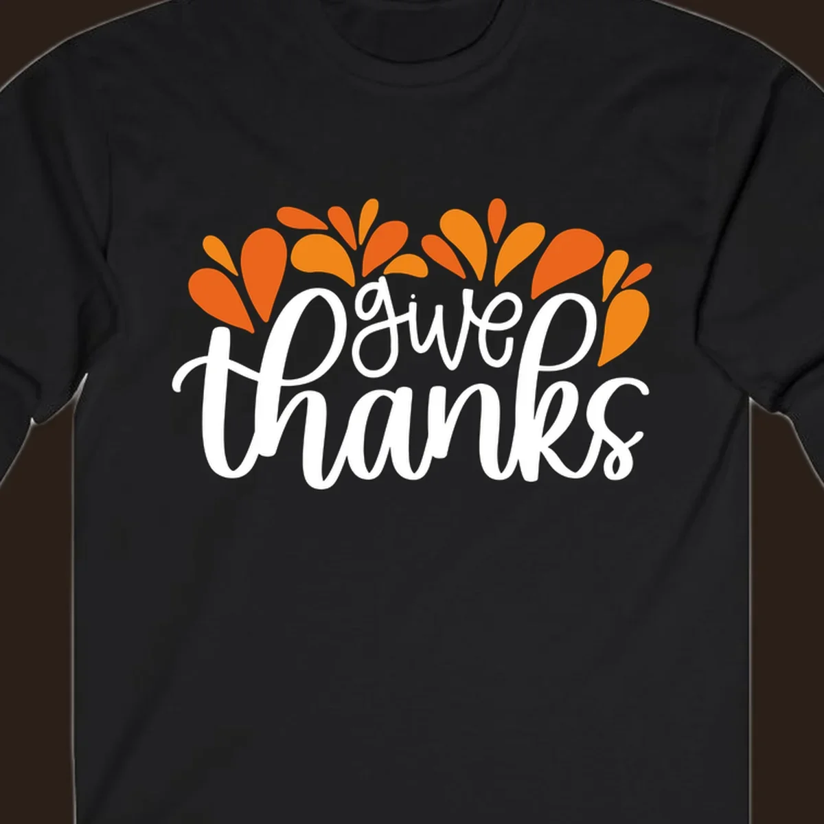 give thanks leaves design with white script text and orange leaf shapes