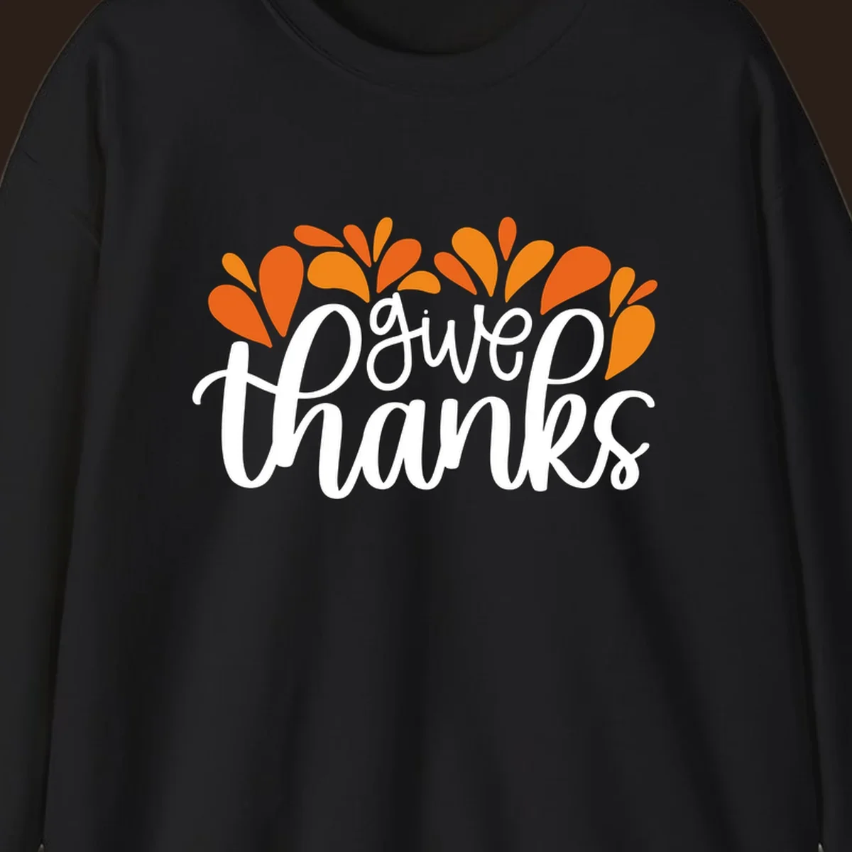 give thanks leaves design with white script text and orange leaf shapes