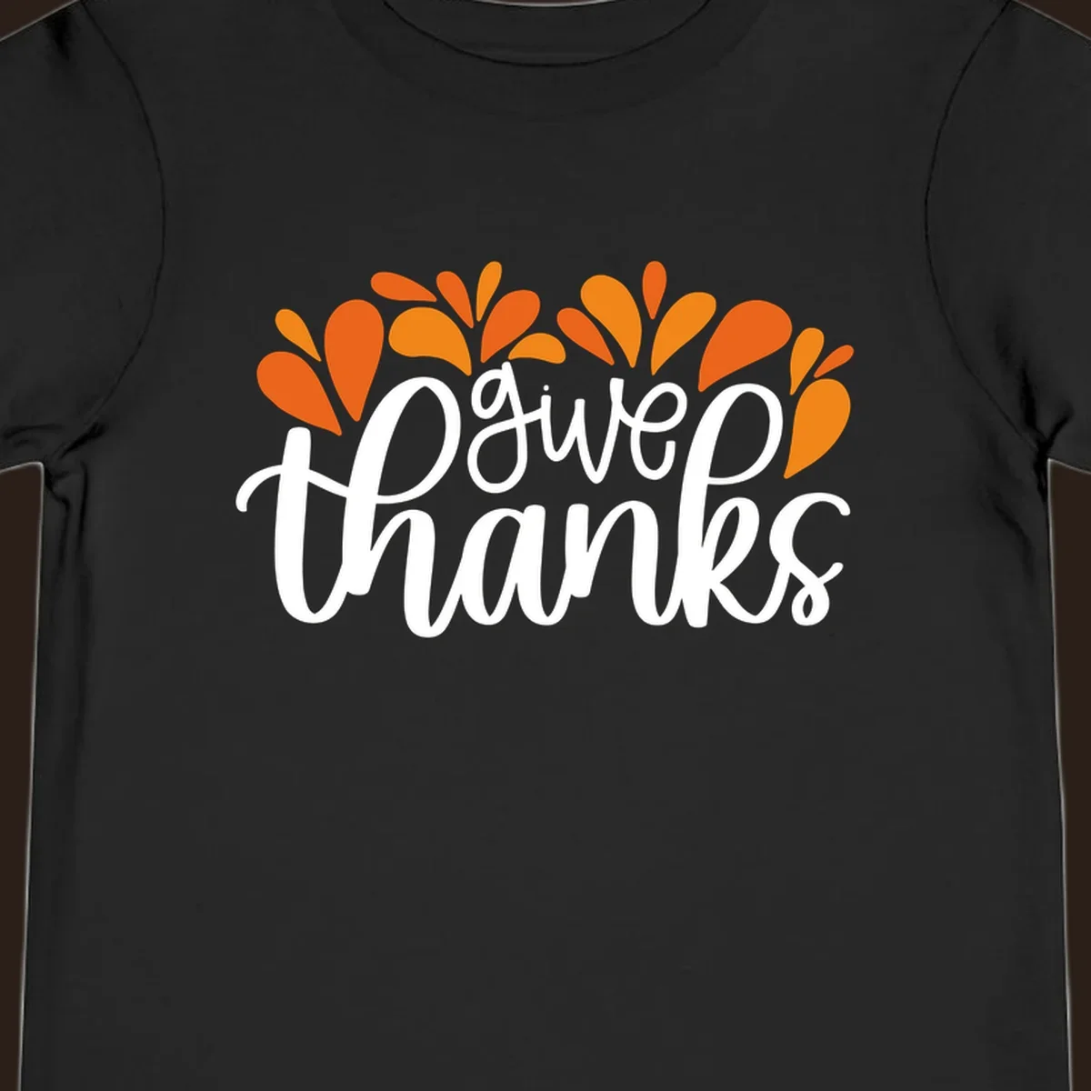 give thanks leaves design with white script text and orange leaf shapes