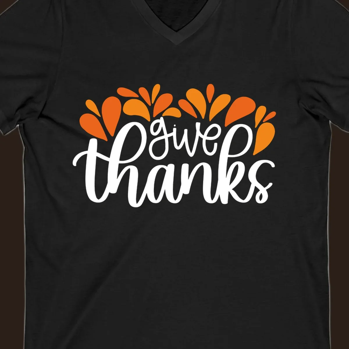 give thanks leaves design with white script text and orange leaf shapes