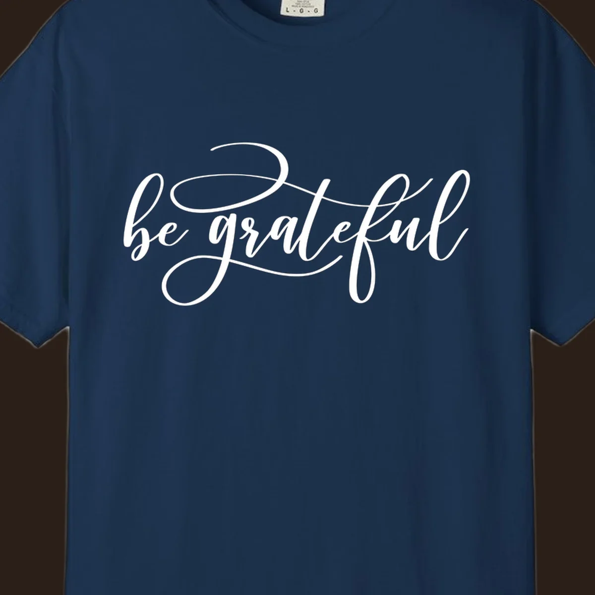 White script text that says 'be grateful' on a black background.