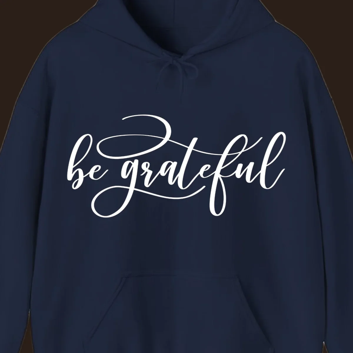 White script text that says 'be grateful' on a black background.