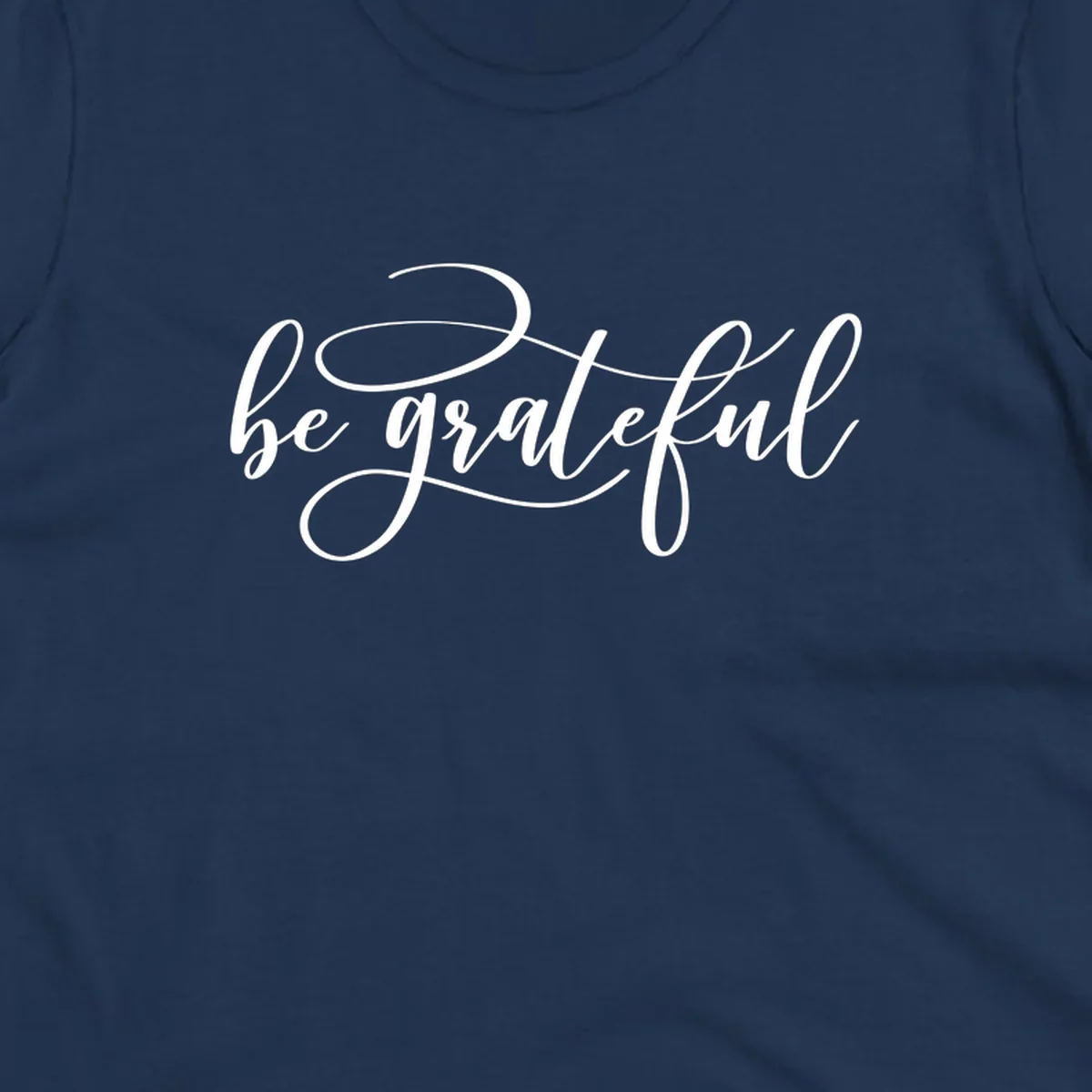 White script text that says 'be grateful' on a black background.