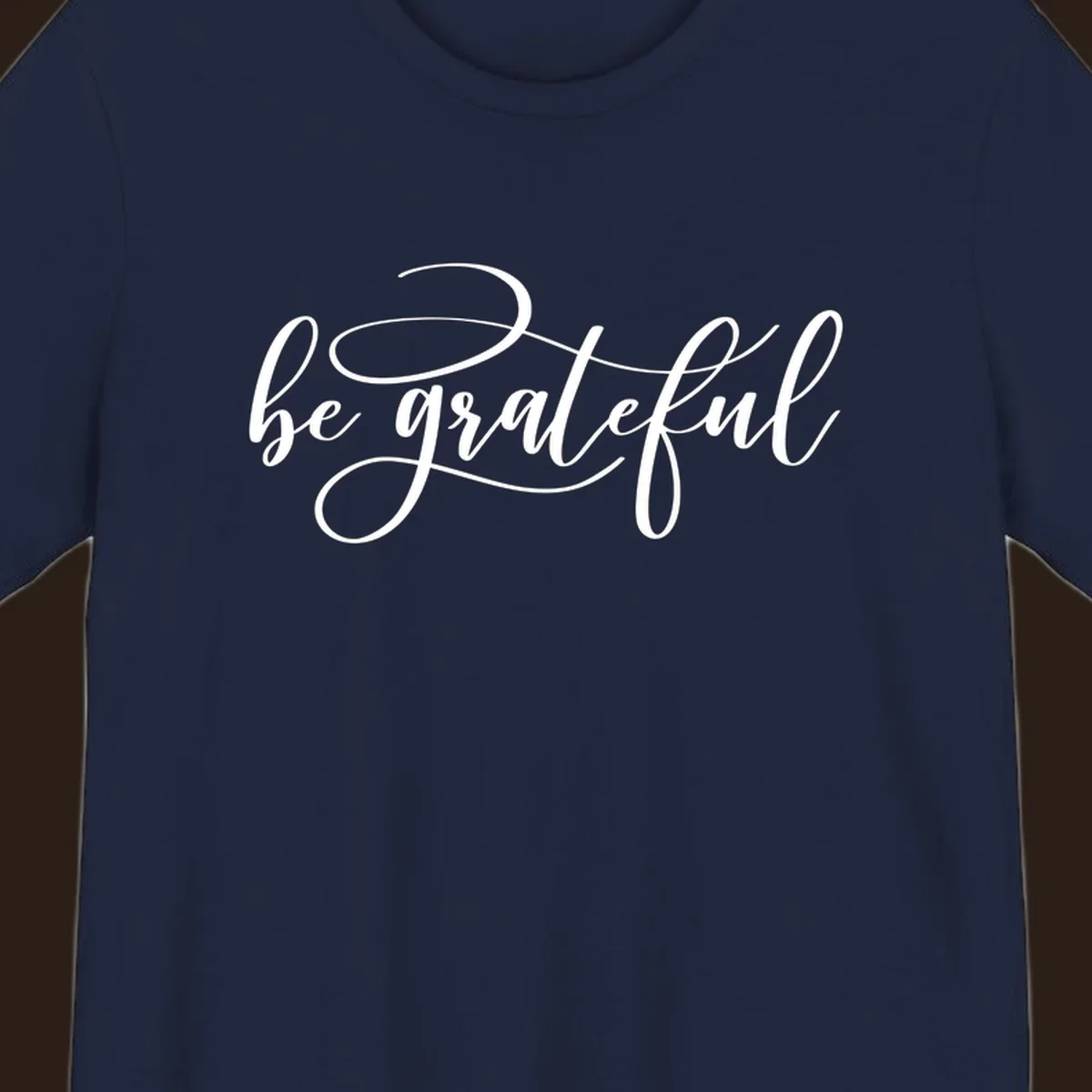 White script text that says 'be grateful' on a black background.