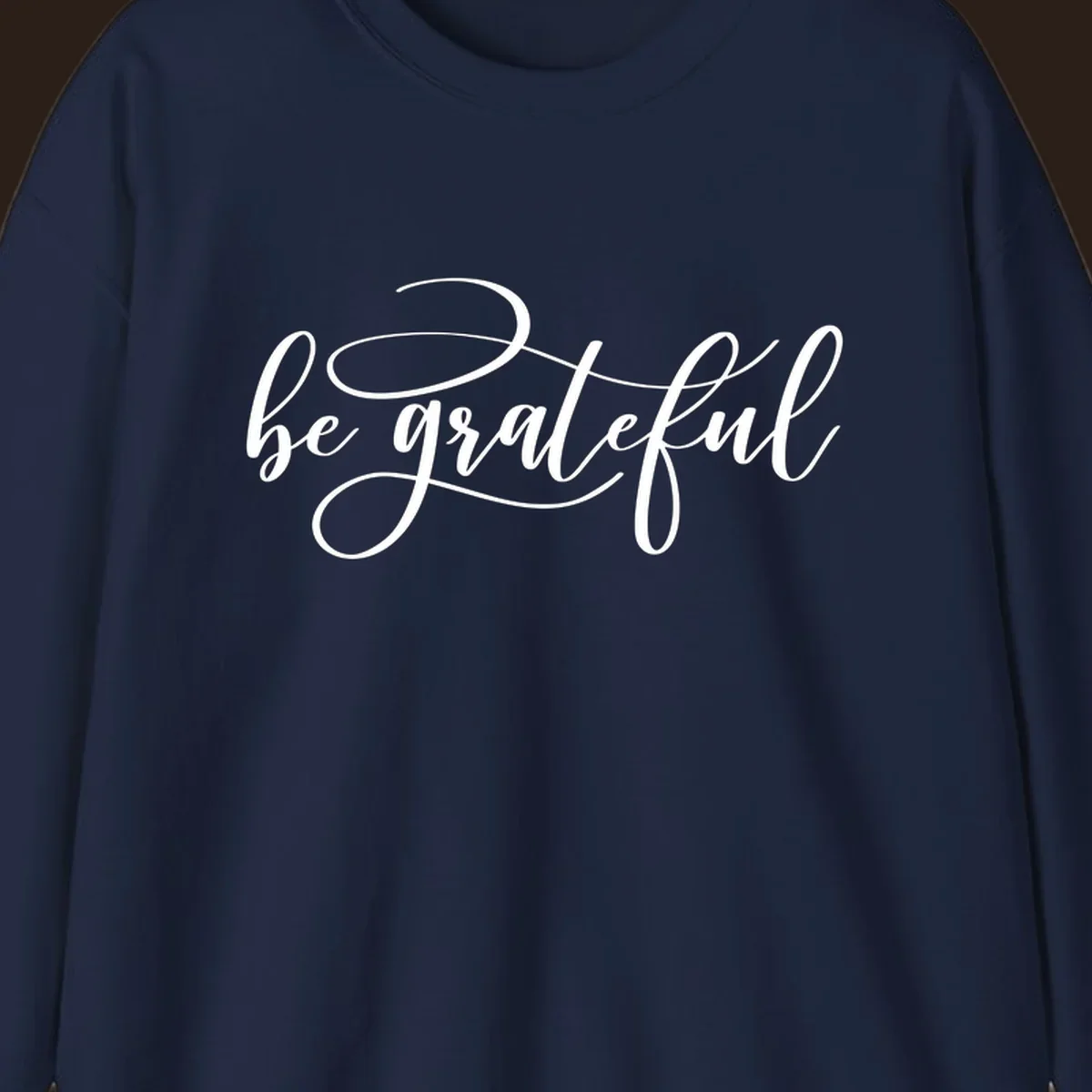 White script text that says 'be grateful' on a black background.