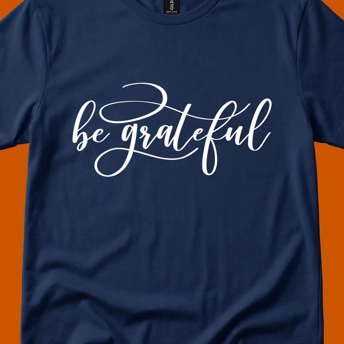 White script text that says 'be grateful' on a black background.