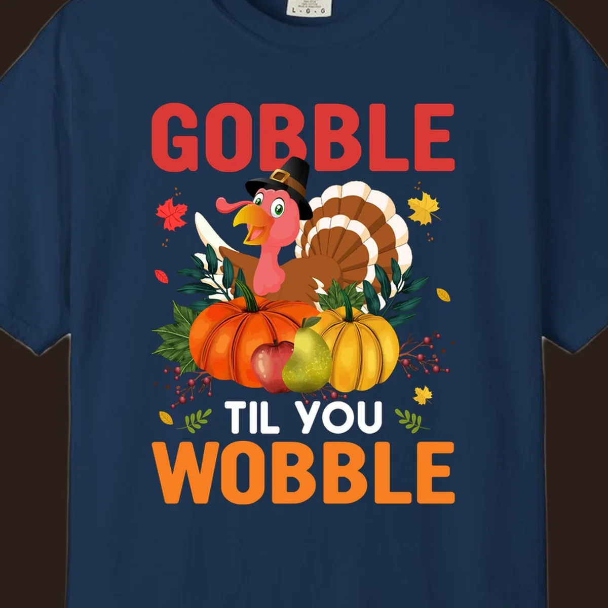 Gobble Til You Wobble Thanksgiving turkey illustration with pumpkins and text.