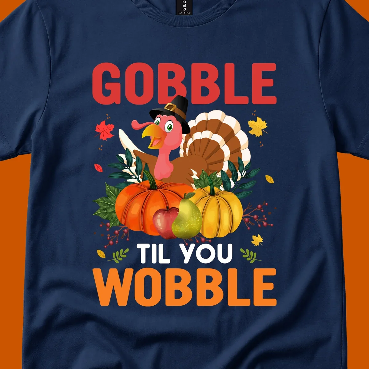 Gobble Til You Wobble Thanksgiving turkey illustration with pumpkins and text.