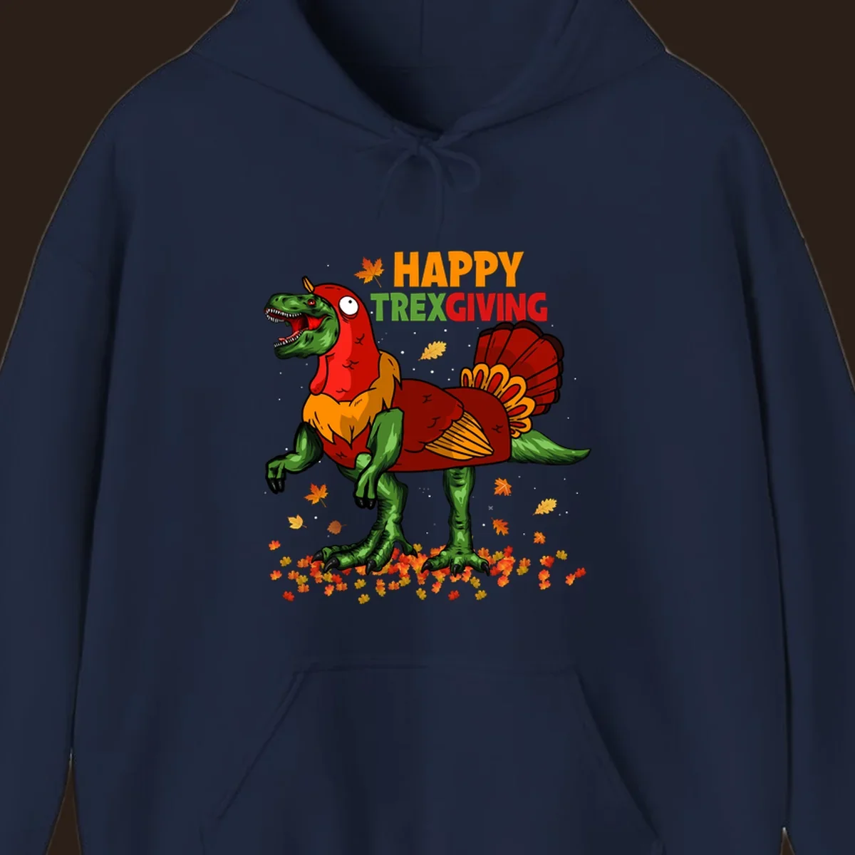 Dinosaur in a turkey costume with 'Happy Trexgiving' text and fall leaves.