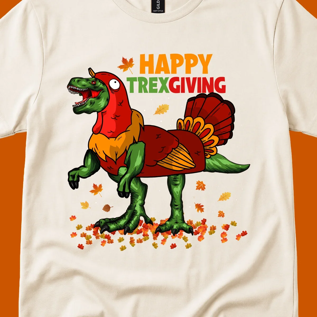 Dinosaur in a turkey costume with 'Happy Trexgiving' text and fall leaves.