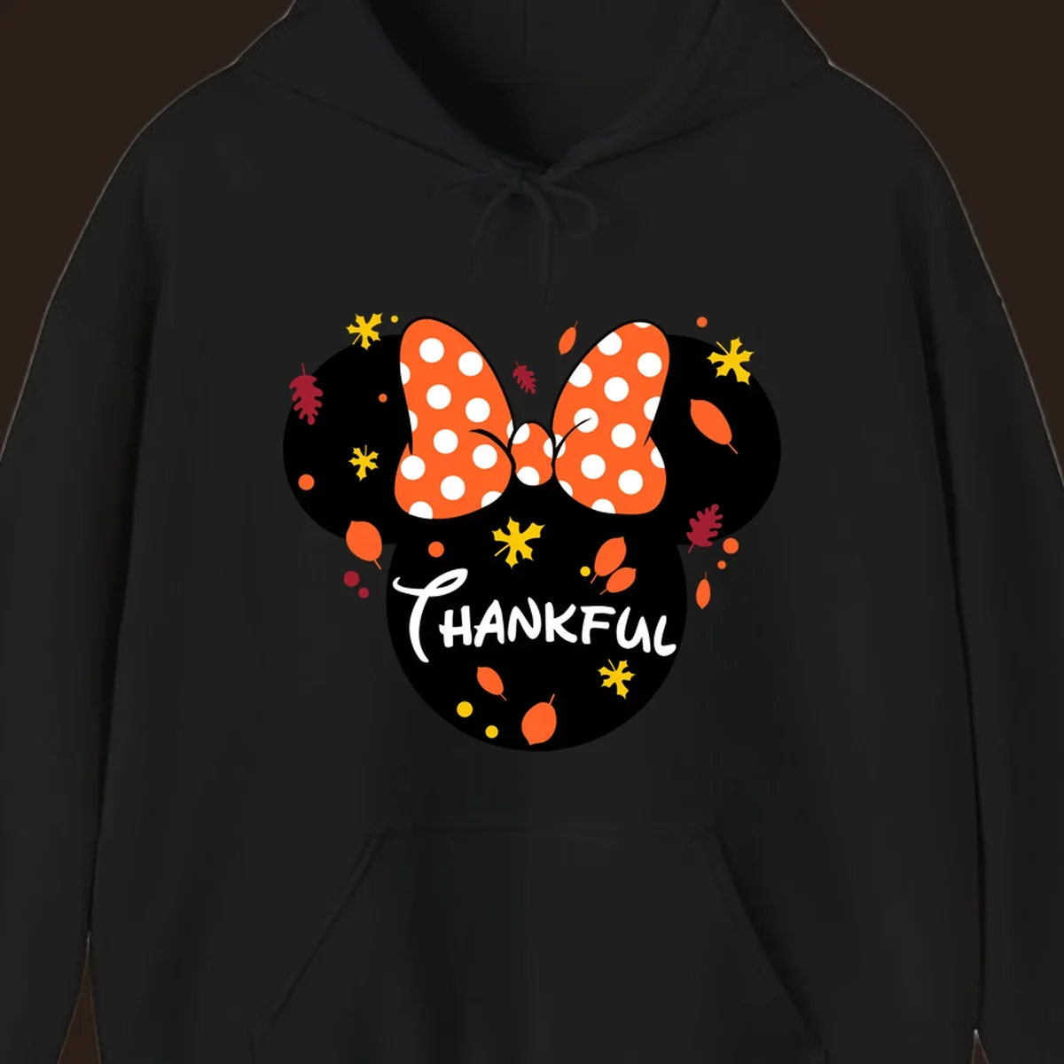 Minnie Mouse silhouette with polka dot bow and 'THANKFUL' text, surrounded by fall leaves.