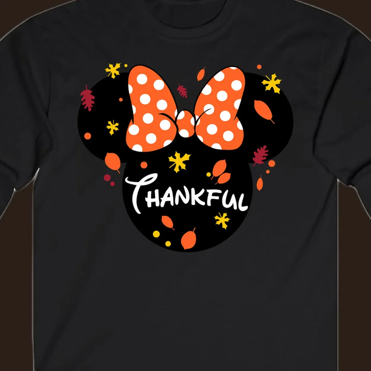 Minnie Mouse silhouette with polka dot bow and 'THANKFUL' text, surrounded by fall leaves.