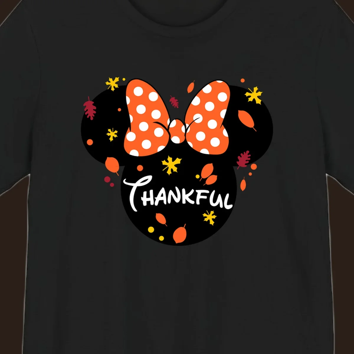 Minnie Mouse silhouette with polka dot bow and 'THANKFUL' text, surrounded by fall leaves.