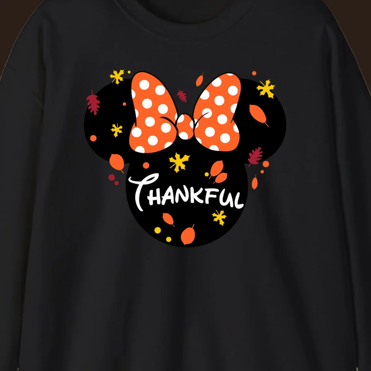 Minnie Mouse silhouette with polka dot bow and 'THANKFUL' text, surrounded by fall leaves.