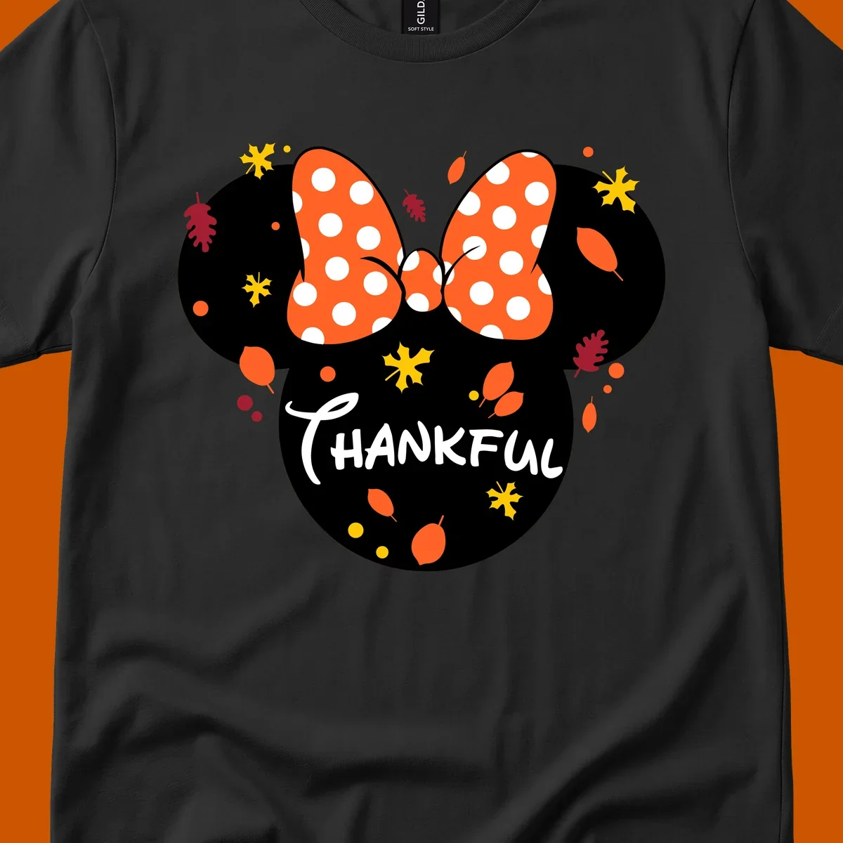 Minnie Mouse silhouette with polka dot bow and 'THANKFUL' text, surrounded by fall leaves.