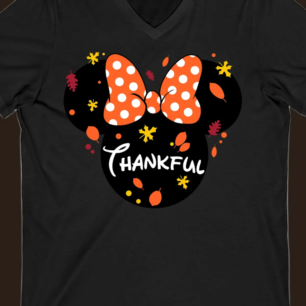 Minnie Mouse silhouette with polka dot bow and 'THANKFUL' text, surrounded by fall leaves.