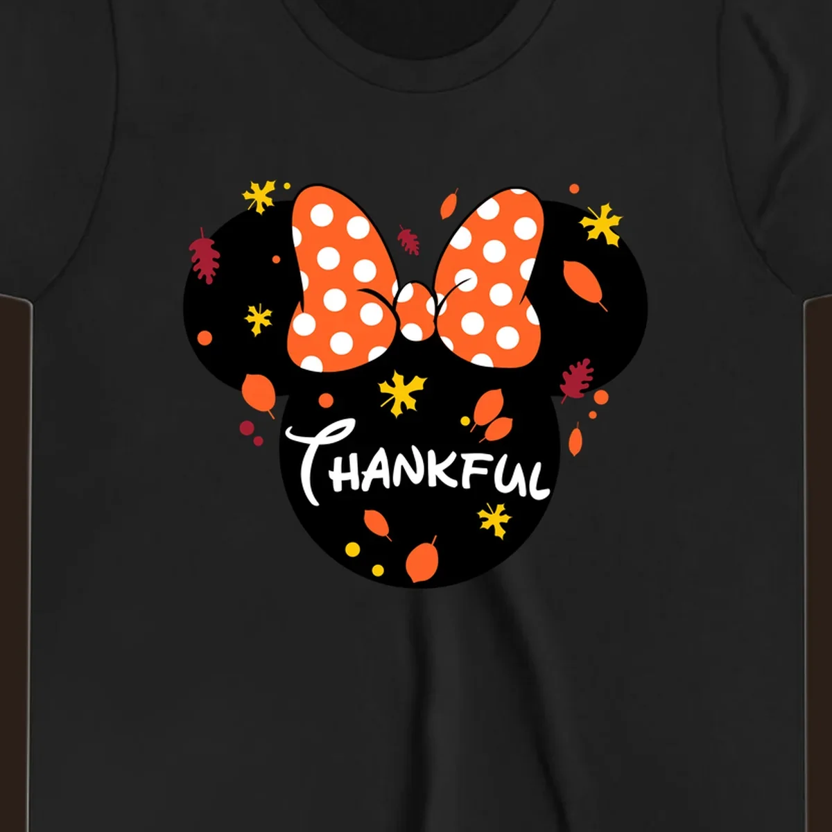 Minnie Mouse silhouette with polka dot bow and 'THANKFUL' text, surrounded by fall leaves.