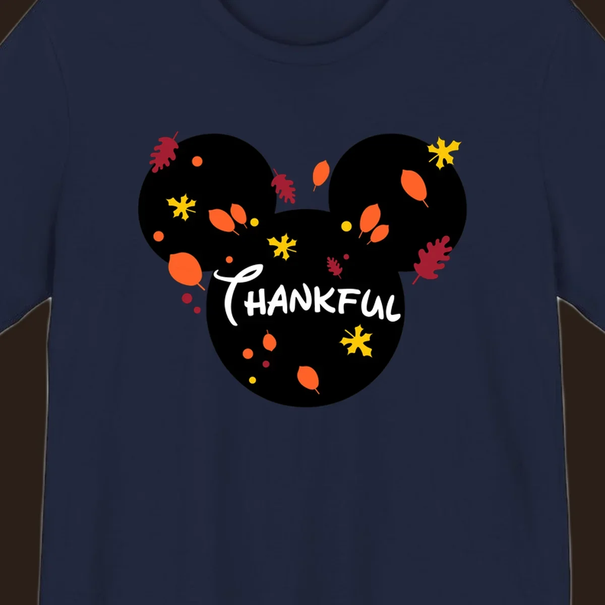 Mickey ears shape with fall leaves and the word THANKFUL in white text.