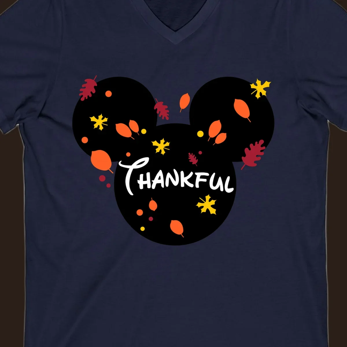 Mickey ears shape with fall leaves and the word THANKFUL in white text.