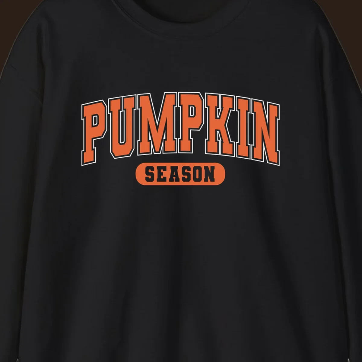 Pumpkin Season varsity text design in orange and white on black background.