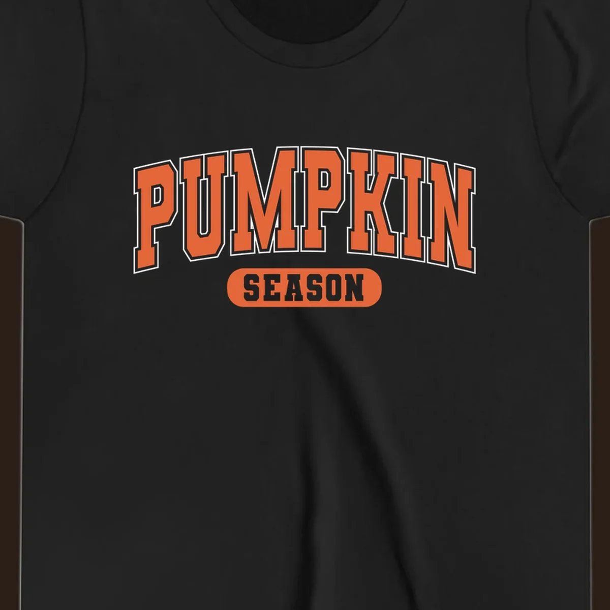 Pumpkin Season varsity text design in orange and white on black background.