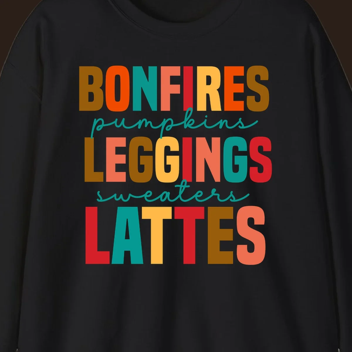 Fall vibes text design with words like Bonfires, Pumpkins, Leggings, Sweaters, Lattes in colorful block letters.