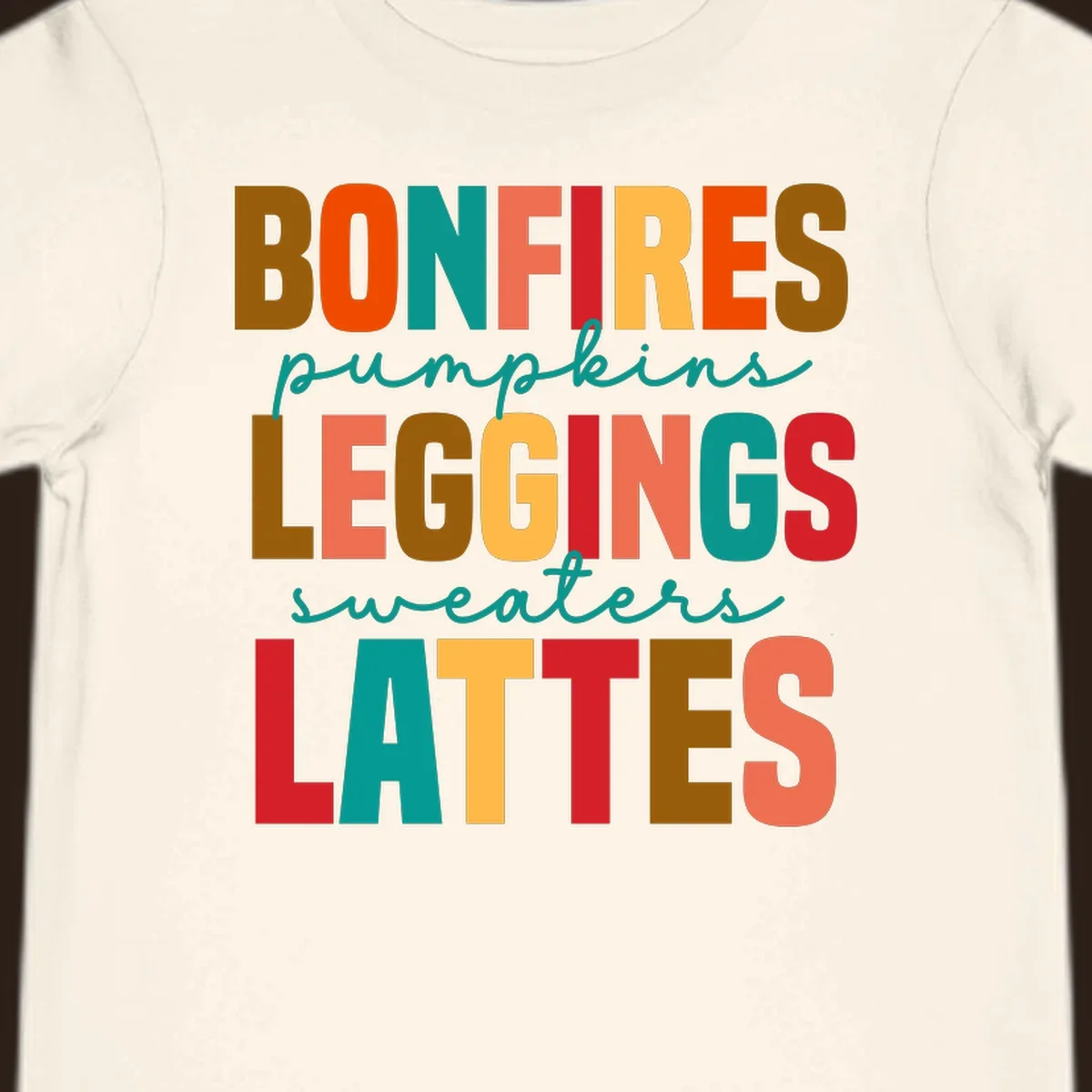 Fall vibes text design with words like Bonfires, Pumpkins, Leggings, Sweaters, Lattes in colorful block letters.