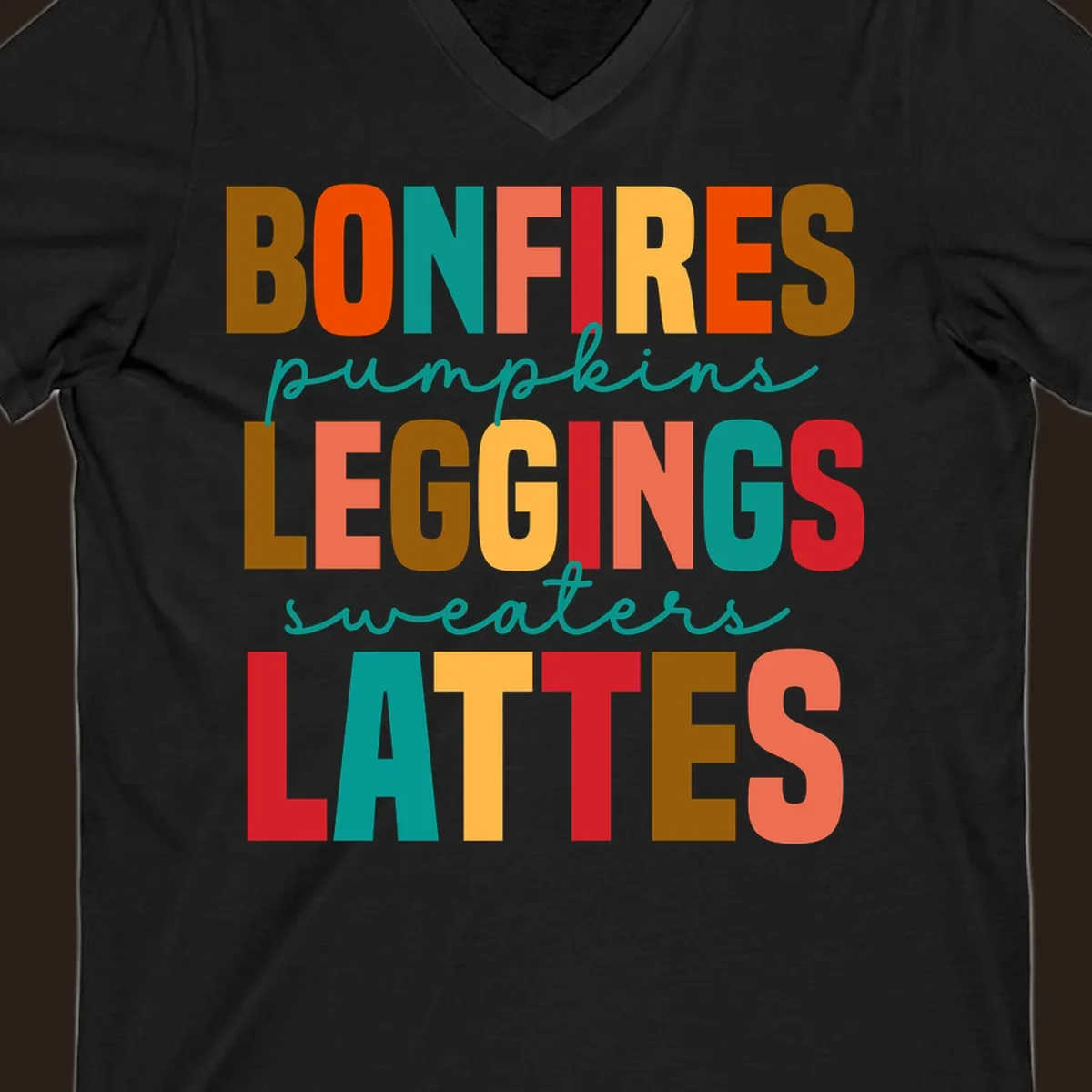Fall vibes text design with words like Bonfires, Pumpkins, Leggings, Sweaters, Lattes in colorful block letters.