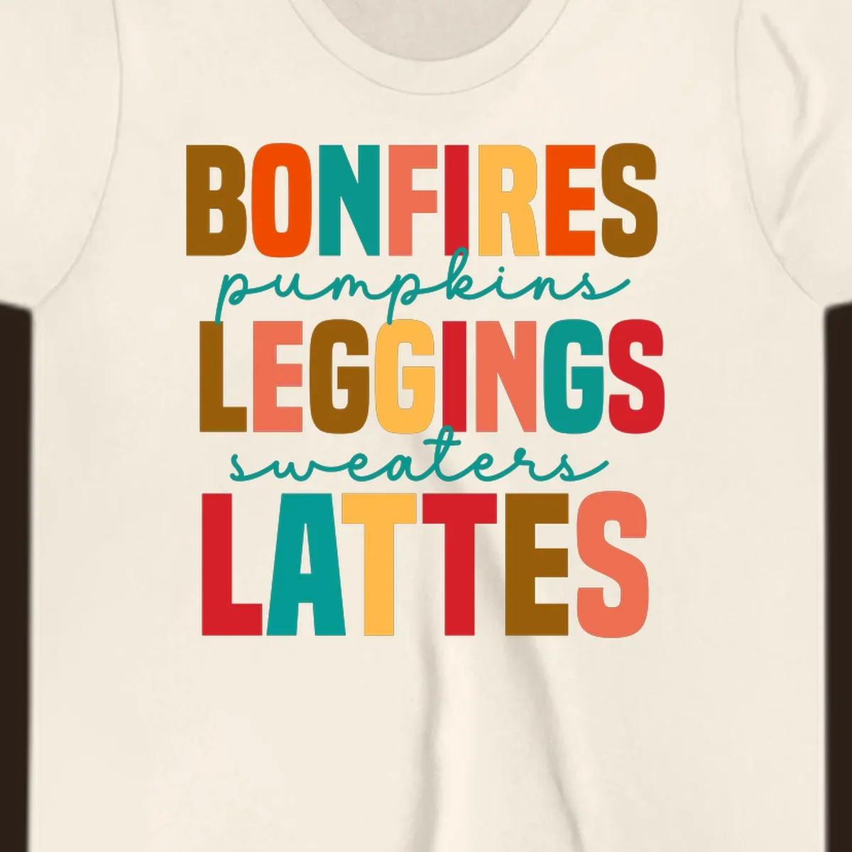 Fall vibes text design with words like Bonfires, Pumpkins, Leggings, Sweaters, Lattes in colorful block letters.