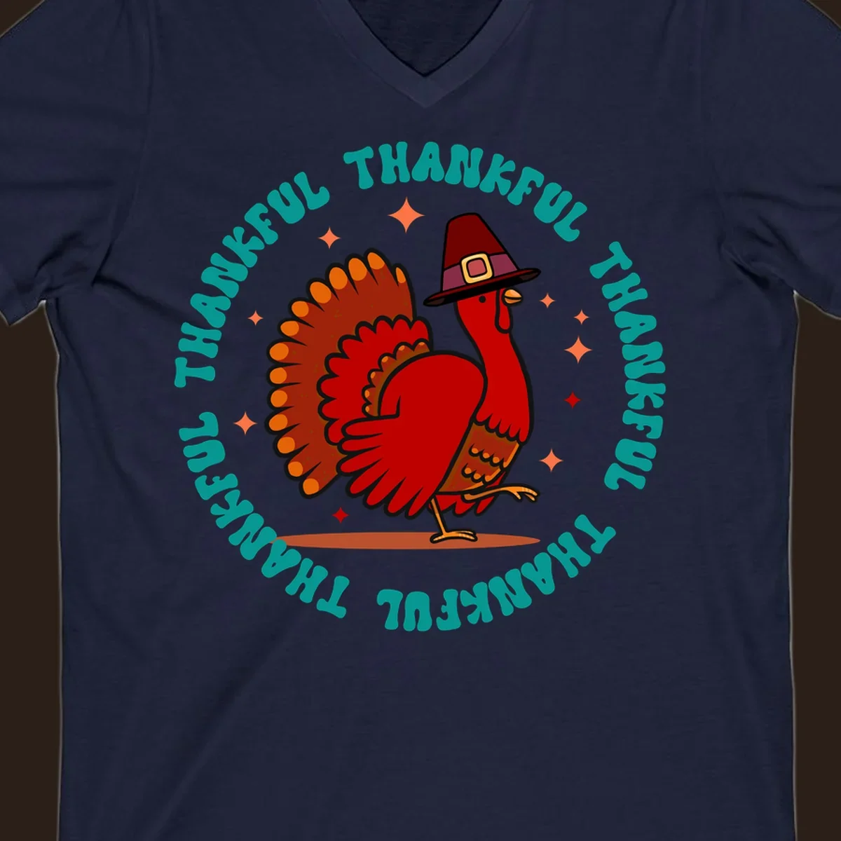 Thanksgiving turkey wearing a pilgrim hat with 'THANKFUL' text and starbursts.