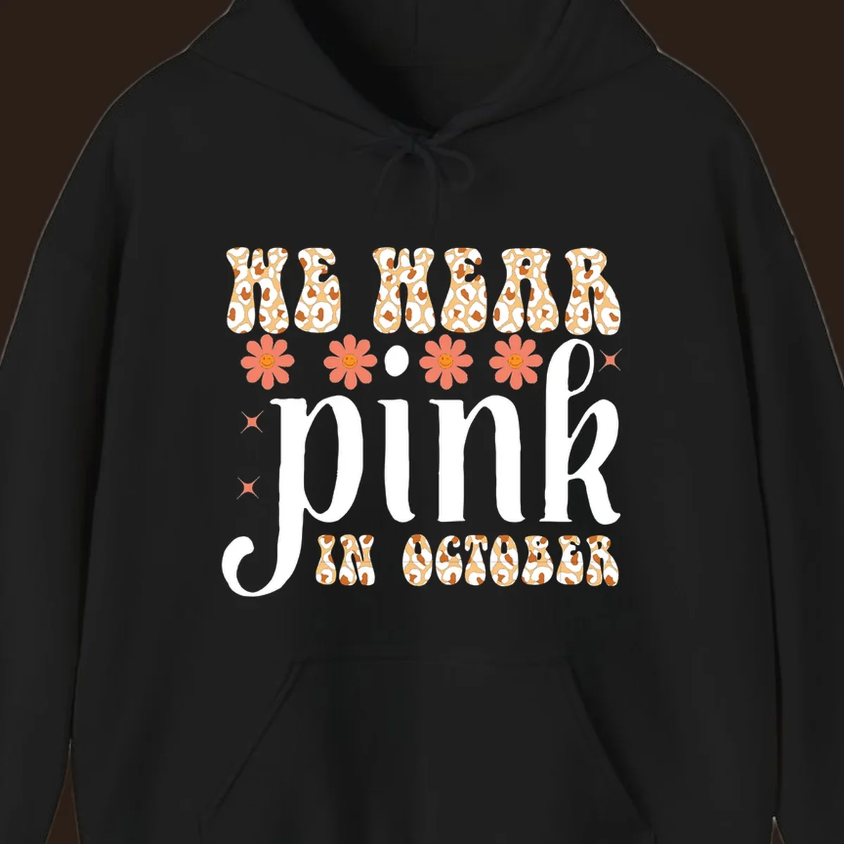 Retro "WE WEAR pink IN OCTOBER" design with leopard print and smiling flowers.
