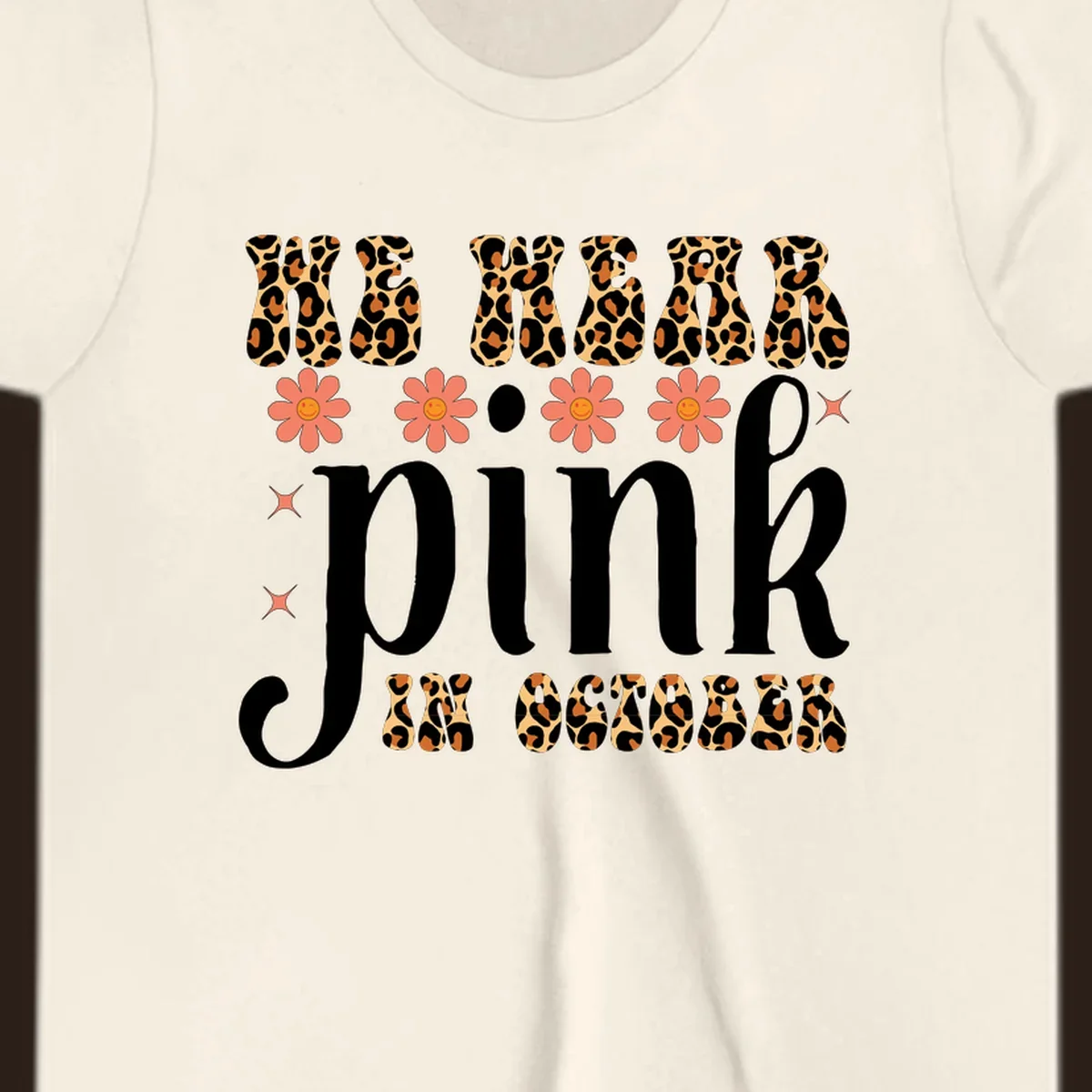 Retro "WE WEAR pink IN OCTOBER" design with leopard print and smiling flowers.