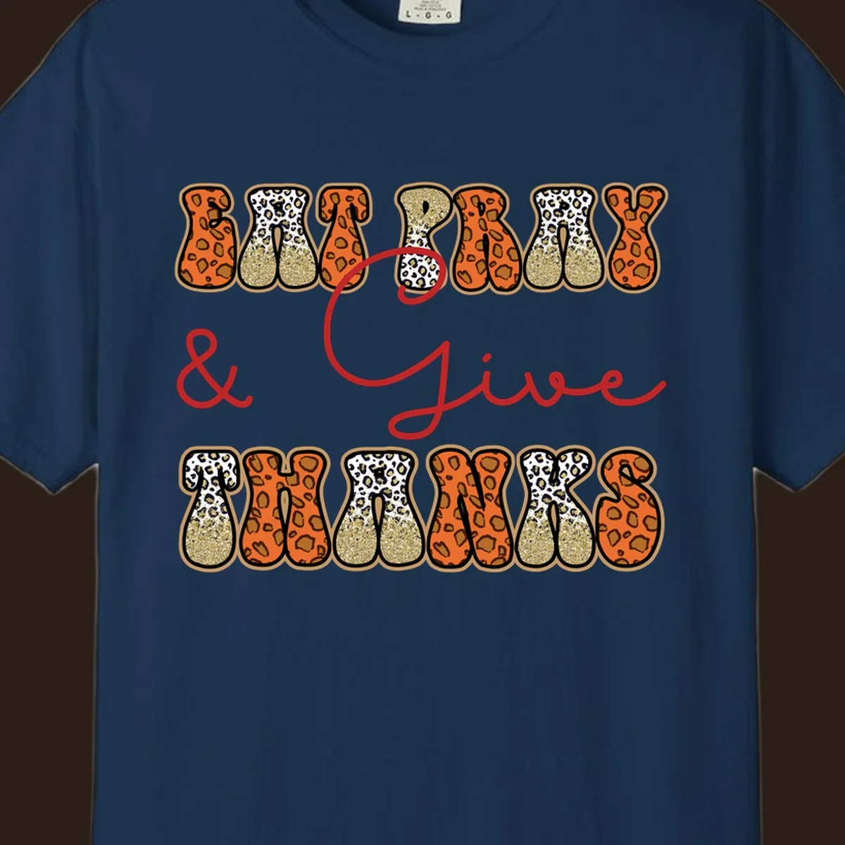 Eat Pray Give Thanks leopard print text design with gold glitter accents.