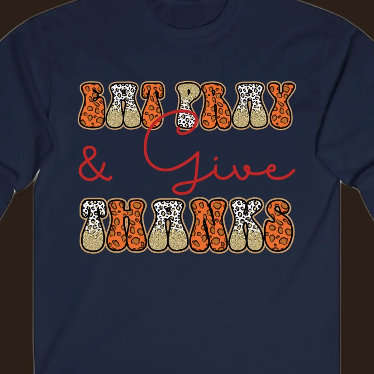 Eat Pray Give Thanks leopard print text design with gold glitter accents.